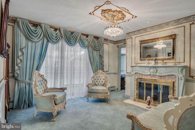 living area featuring a fireplace, light carpet, a chandelier, and a baseboard heating unit