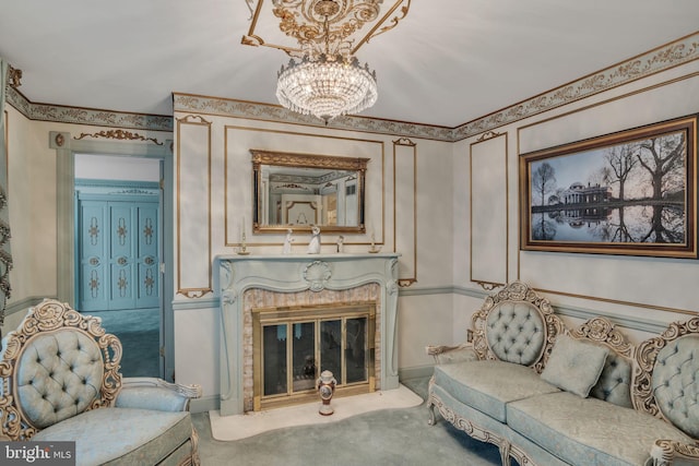 living area featuring a high end fireplace, carpet, and an inviting chandelier