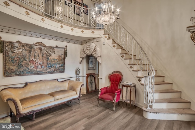 interior space with a chandelier, hardwood / wood-style floors, and a towering ceiling