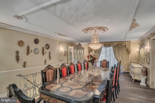 dining area with crown molding, wood-type flooring, and a notable chandelier