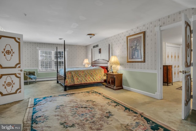 bedroom featuring light colored carpet and a baseboard heating unit