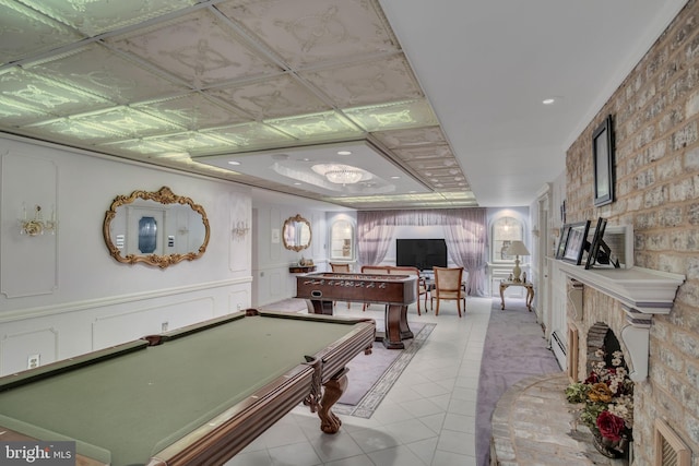 recreation room with light tile patterned floors, billiards, and a baseboard heating unit