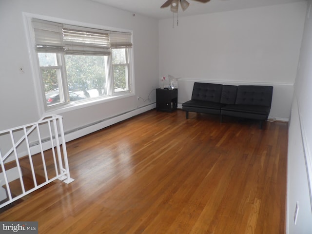 unfurnished room featuring baseboard heating, ceiling fan, and hardwood / wood-style flooring