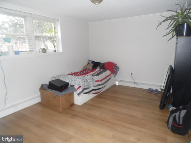 bedroom featuring hardwood / wood-style floors and ornamental molding