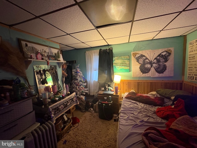 bedroom with a paneled ceiling and carpet flooring