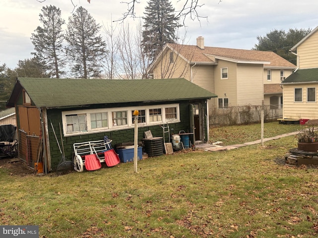 back of house with a lawn