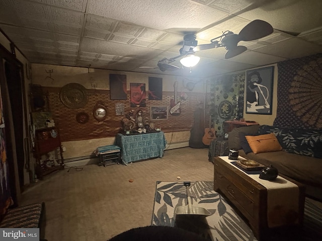 interior space with ceiling fan, carpet, and a baseboard heating unit