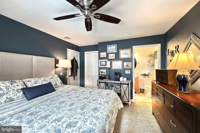 bedroom with light carpet, ceiling fan, and ensuite bath