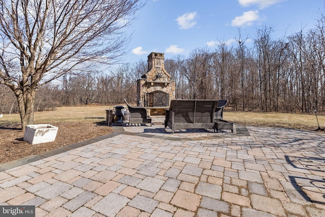 view of patio / terrace with an outdoor stone fireplace