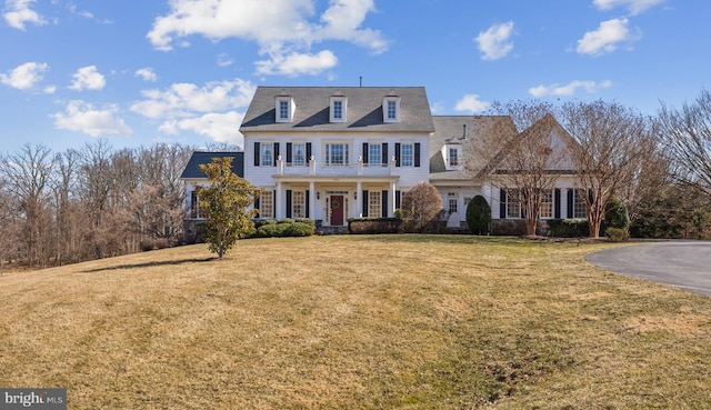 view of front of house with a porch and a front lawn