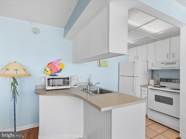 kitchen with white appliances, extractor fan, sink, light tile patterned floors, and white cabinetry