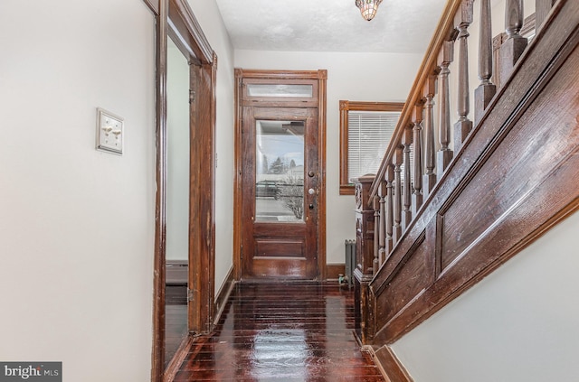 foyer featuring a textured ceiling and dark wood-type flooring