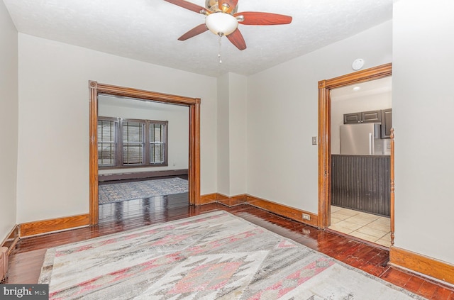 unfurnished room featuring ceiling fan and wood-type flooring