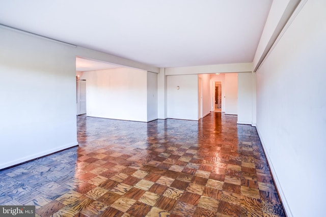 empty room with dark parquet flooring