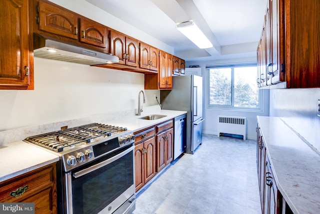 kitchen featuring radiator, sink, and appliances with stainless steel finishes