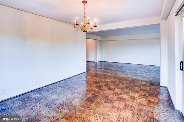 empty room with dark parquet flooring and an inviting chandelier