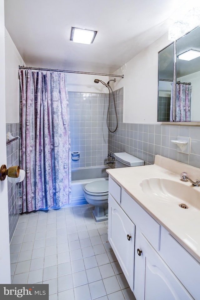 full bathroom with toilet, tile walls, vanity, shower / bath combination with curtain, and tile patterned flooring