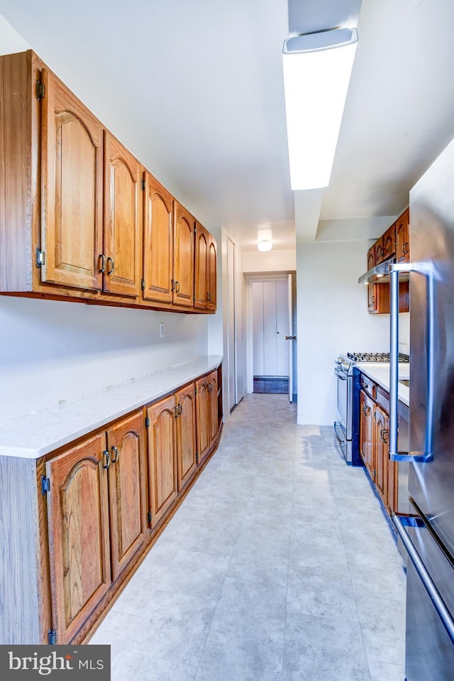 kitchen featuring appliances with stainless steel finishes and light stone counters