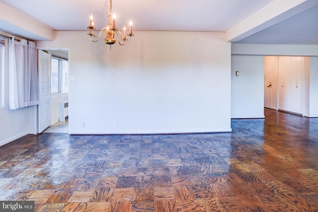 unfurnished room featuring radiator heating unit, dark parquet floors, and a notable chandelier