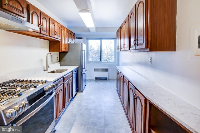 kitchen featuring stainless steel appliances, sink, and radiator heating unit