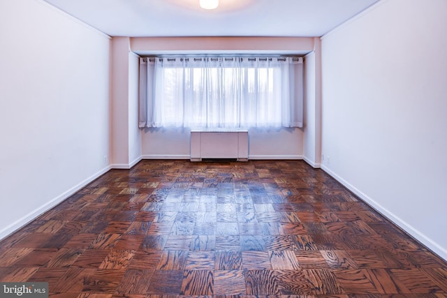 unfurnished room with dark parquet floors