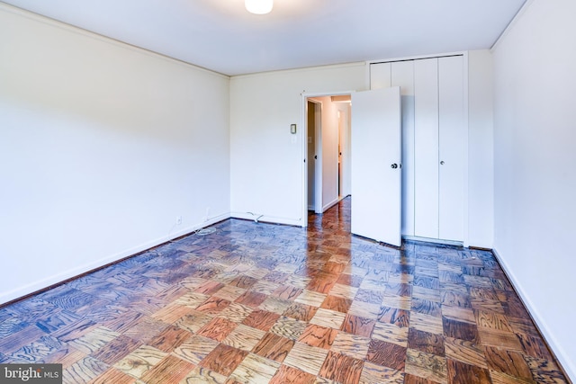 spare room featuring parquet floors