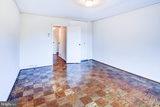 unfurnished room featuring parquet flooring