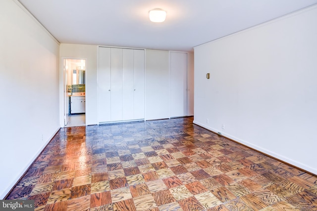 unfurnished bedroom featuring parquet flooring