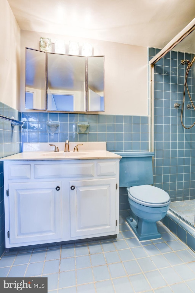 bathroom with walk in shower, vanity, toilet, and tile walls