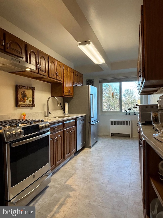 kitchen with radiator, stainless steel appliances, and sink