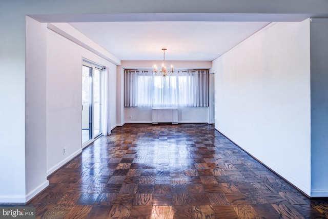 unfurnished room featuring dark parquet flooring and a chandelier