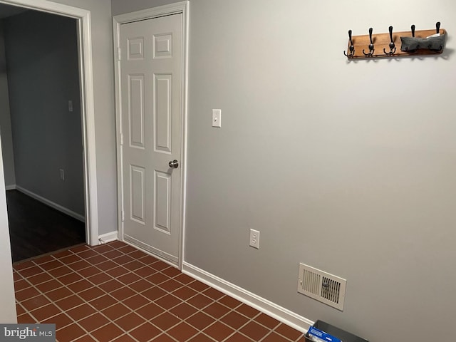 unfurnished room featuring visible vents and baseboards