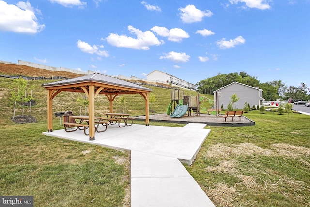 view of property's community with a gazebo, a playground, and a lawn