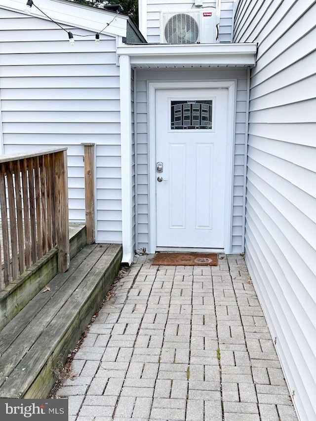 view of exterior entry featuring ac unit