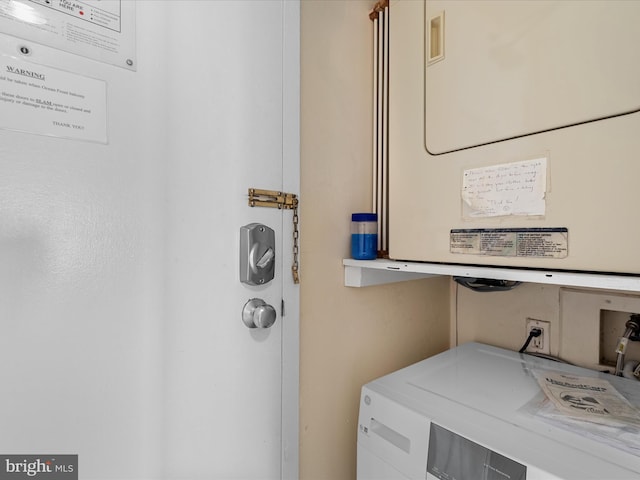 laundry area with stacked washer / drying machine