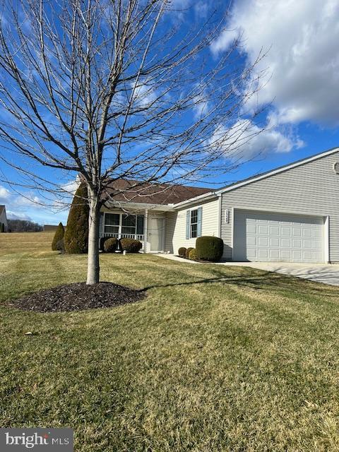 single story home with a garage and a front yard