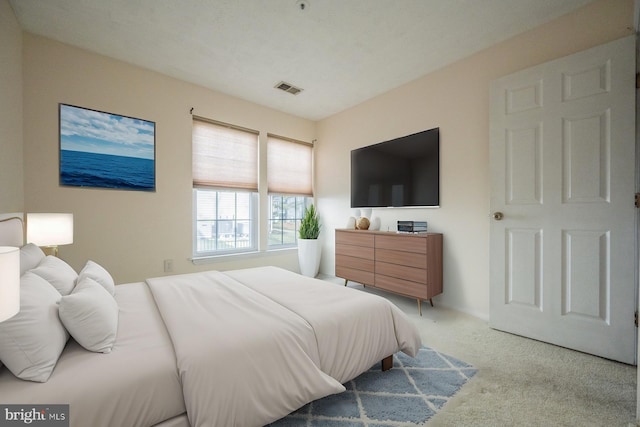 bedroom with light colored carpet