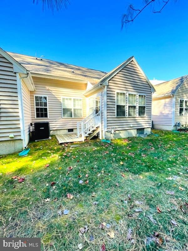 rear view of property with central AC, a yard, and a deck