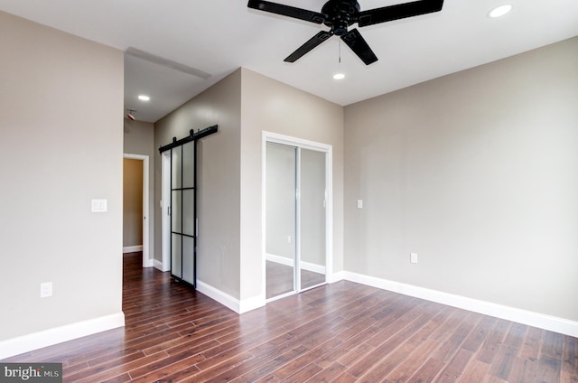 1324 Aisquith St, Baltimore, MD 21202 - spare room featuring a barn door, ceiling fan, wood finished floors, baseboards, and recessed lighting