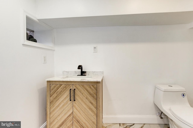 1324 Aisquith St, Baltimore, MD 21202 - bathroom with marble look tiles, toilet, vanity, and baseboards