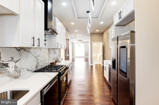 1324 Aisquith St, Baltimore, MD 21202 - kitchen with wall chimney exhaust hood, stainless steel fridge, dark wood finished floors, gas range, and light countertops