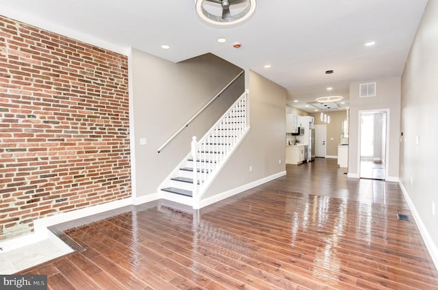 1324 Aisquith St, Baltimore, MD 21202 - unfurnished living room featuring wood finished floors, stairway, and baseboards
