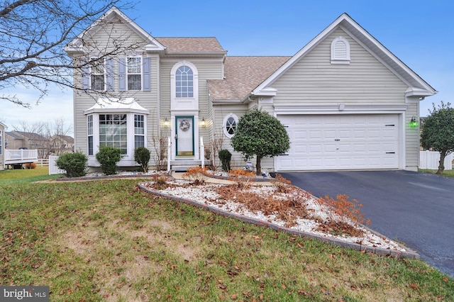 front facade with a garage and a front yard