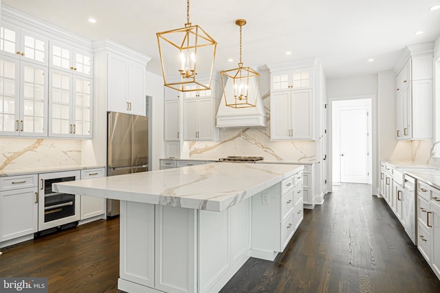 kitchen featuring a center island, white cabinetry, and beverage cooler