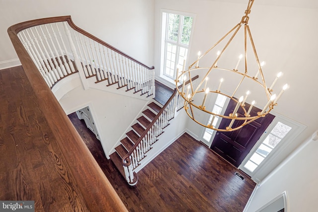 foyer featuring a chandelier and dark hardwood / wood-style flooring