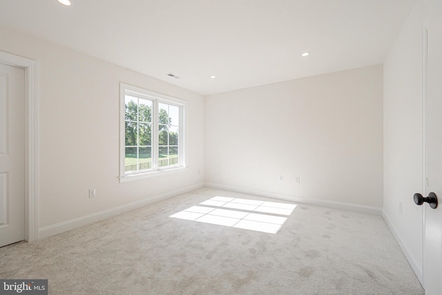 unfurnished room featuring light colored carpet