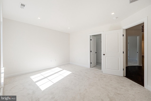 unfurnished bedroom featuring light carpet