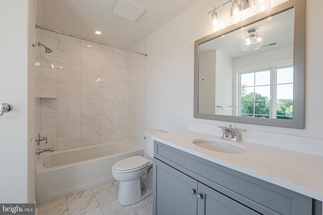 full bathroom with vanity, tiled shower / bath combo, and toilet