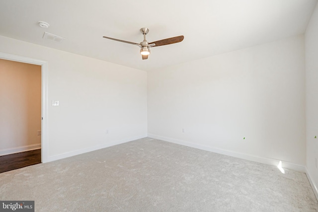 carpeted empty room featuring ceiling fan