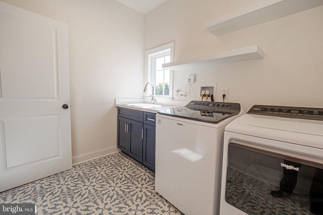 laundry area with washer and clothes dryer, cabinets, and sink